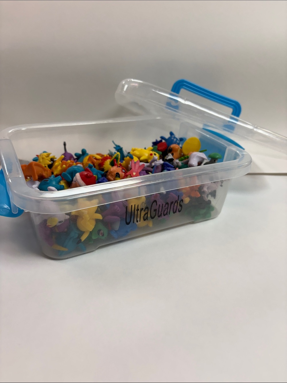 Pokémon Ultra Guards in a Clear Plastic Storage Box with Blue Latches